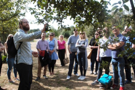 Jason Irving discussing the identification of a crab apple tree and the uses of the fruit on a London foraging course