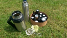 Thermos of elderflower tea and a box of samples of wild food
